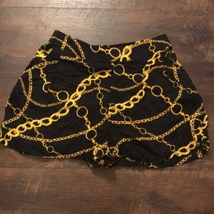 High waisted black shorts with gold chain design